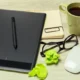 Workspace with digital tablet, notebook, glasses and coffee representing UAE Small Business Relief tax planning
